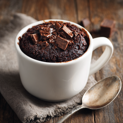 Microwave brownies in a mug topped with melted chocolate chunks