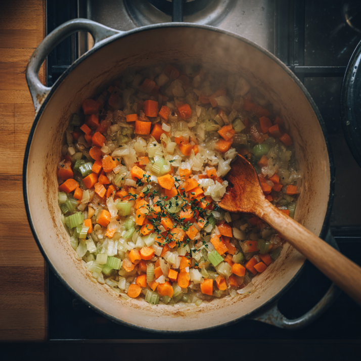 sautéed vegetables for chicken wild rice soup in a Dutch oven