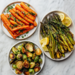 Assorted roasted easy vegetable side dishes including Brussels sprouts, carrots, and green beans