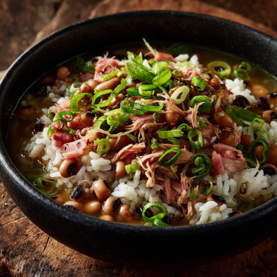 Hoppin’ John with black-eyed peas, ham, and rice in a black bowl